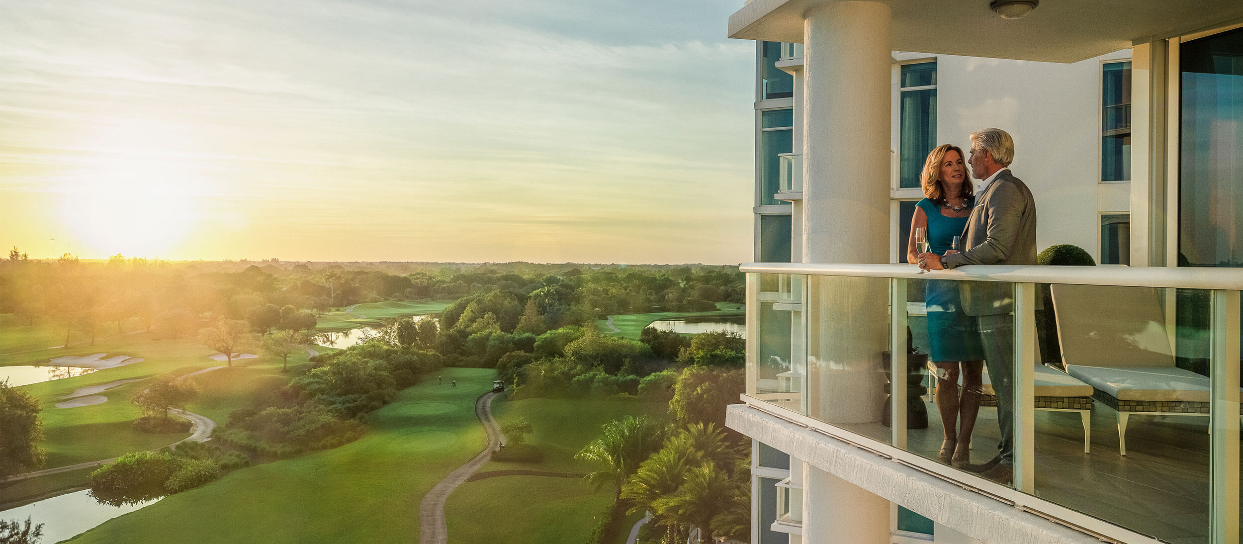 Couple standing on balcony at Akoya Boca West